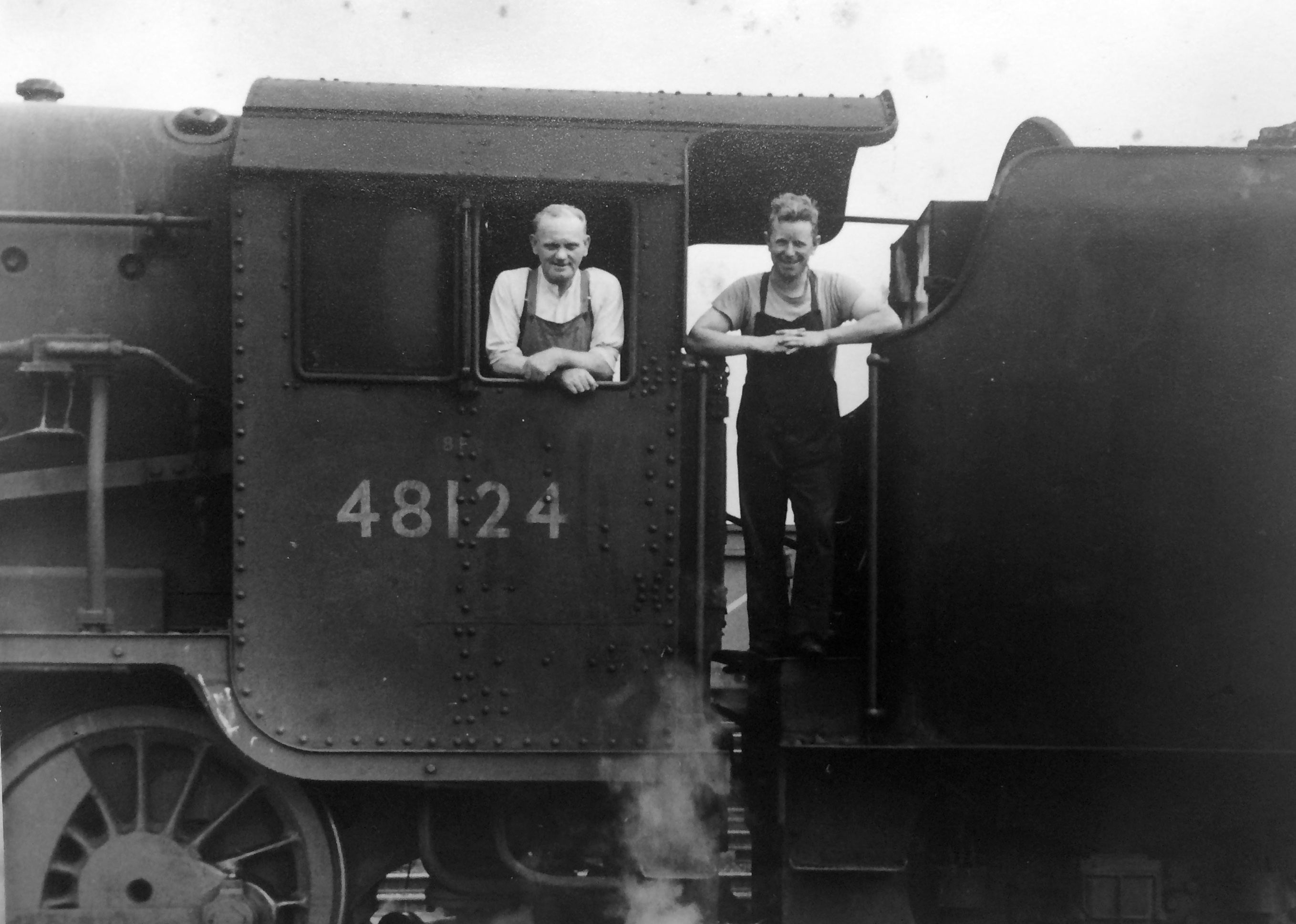 Black & white image of a driver and fireman posing on the footplate of locomotive No. 48124