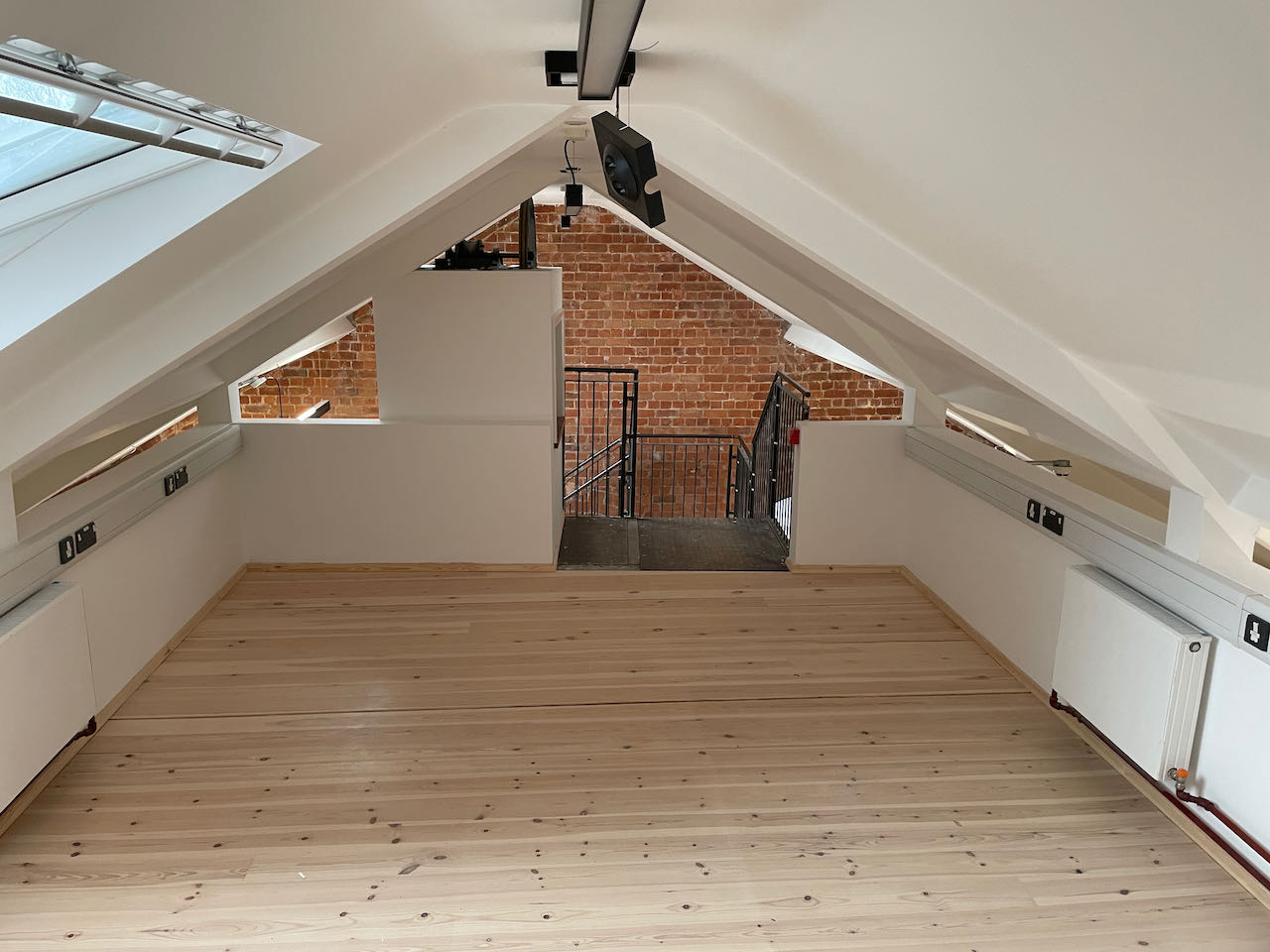 The new Reading Room with the eaves of the ceiling anling above with a bare wooden floor