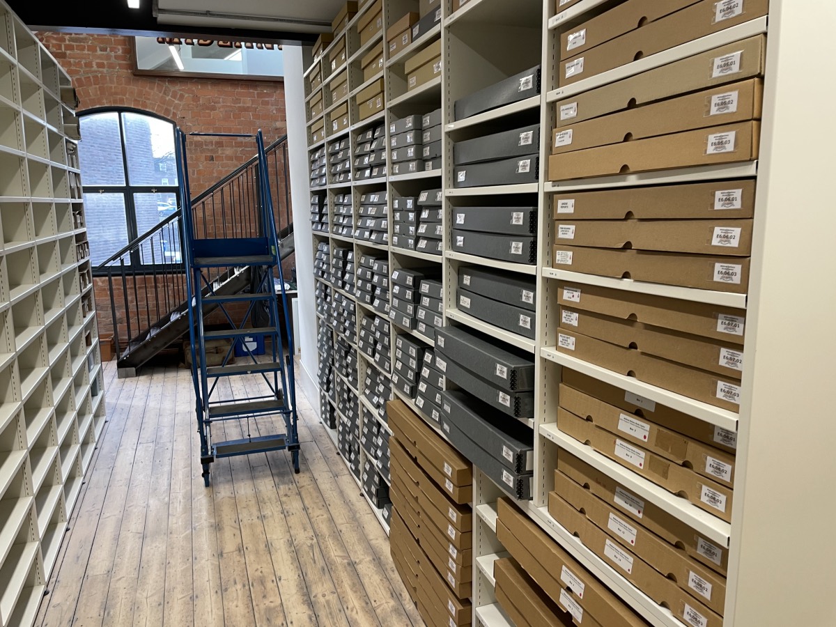 Racks of boxes and a set of steps to reach the top in the Midland Railway Study Centre