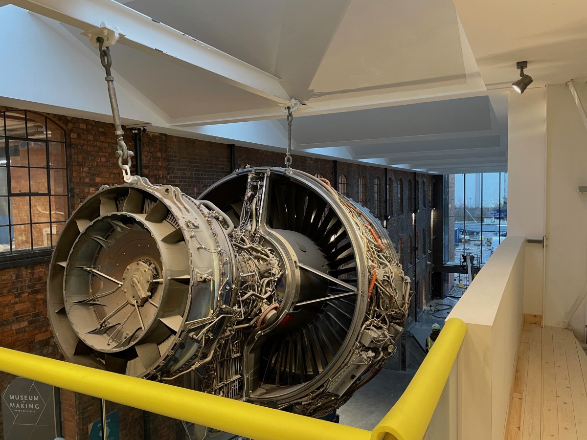 A Rolls-Royce Trent1000 jet engine suspended from the ceiling