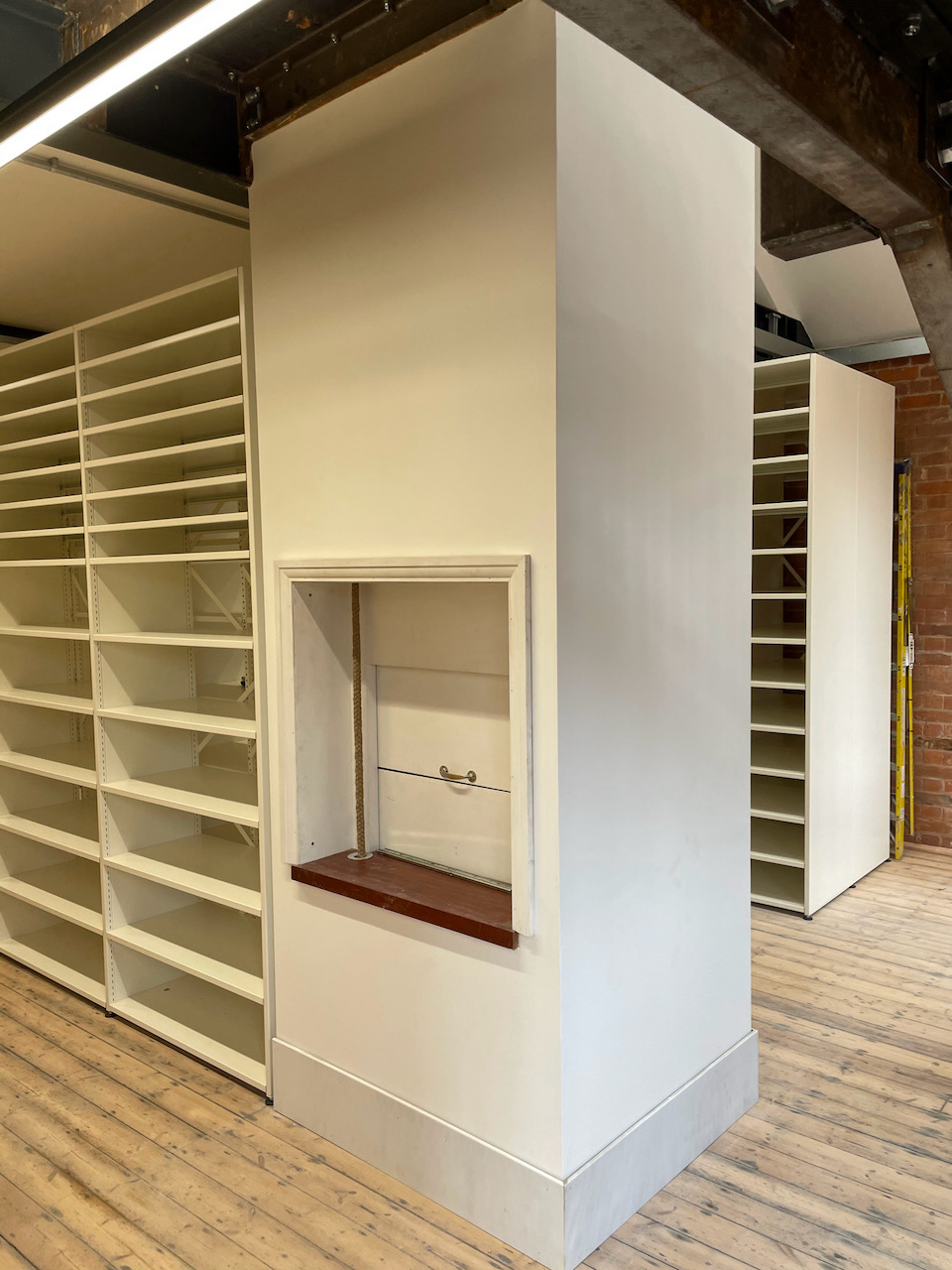 A wooden enclosure containing a dumbwaiter