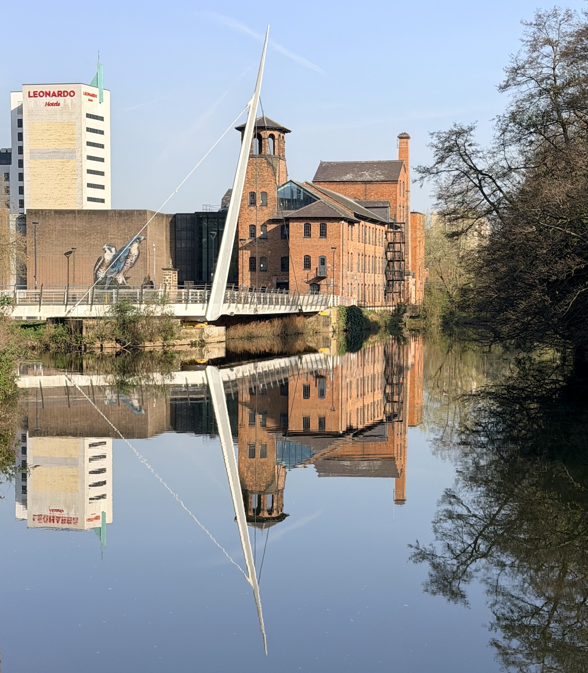 Derby's Silk Mill is seen looking along a very sunny River Derwent.