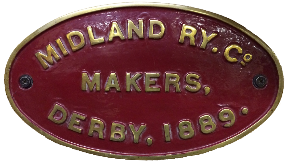 An oval cast brass plaque with maroon background which reads 'Midland Ry Co. -  Makers  -  Derby, 1889.'