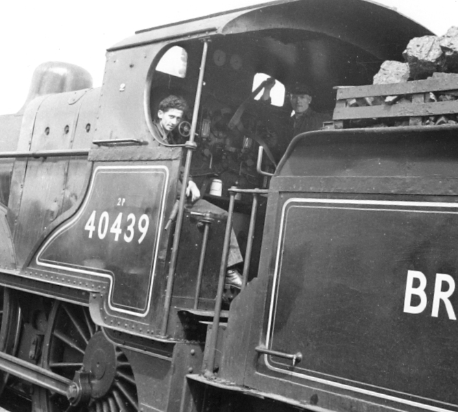 The driver and fireman of locomotive number 40439 are smiling for the photographer from the footplate 