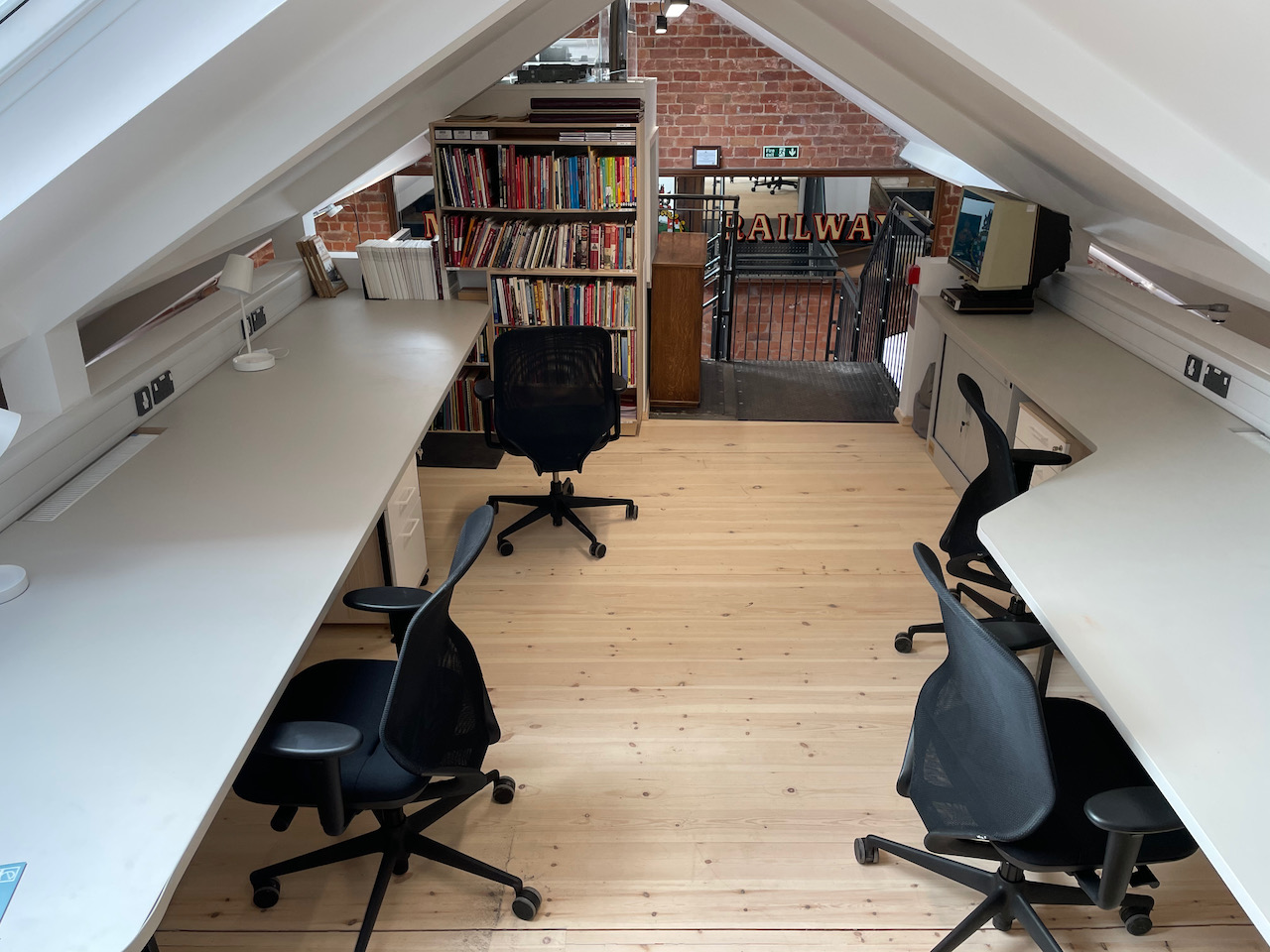 A room built into the eaves of the roof with desks either side and a central circulation space